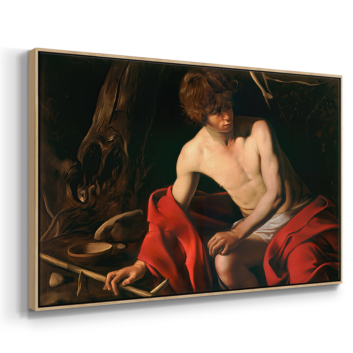 Angled view of Saint John the Baptist in the Wilderness, c. 1603-1604 by Caravaggio in a natural wood floater framed canvas.