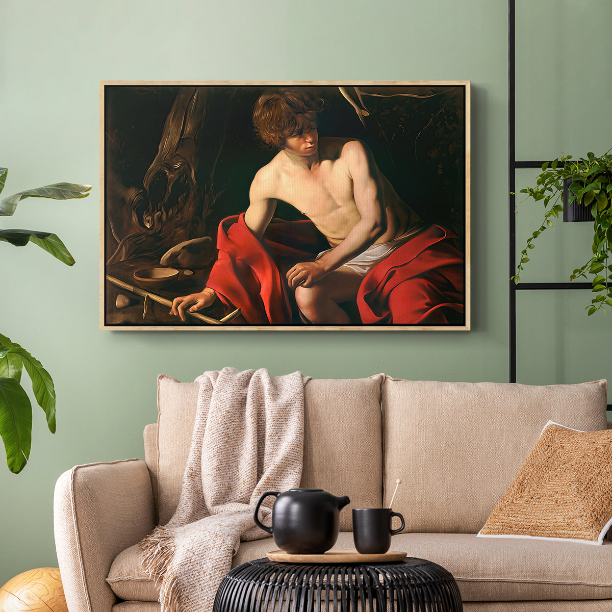 Natural wood floater framed canvas featuring a contemplative religious figure in rustic wilderness environment, displayed above a sofa in a modern living room.