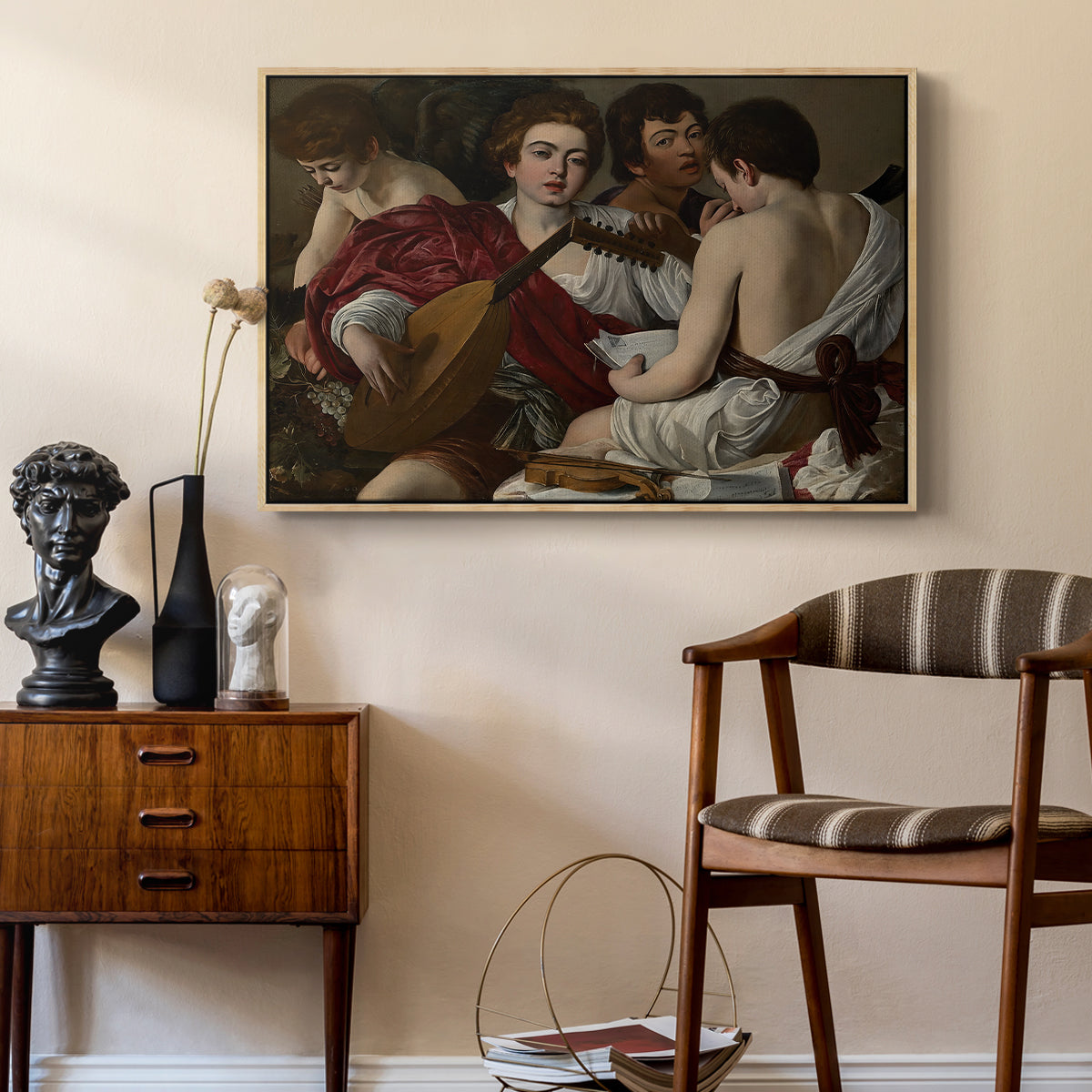 The Musicians, c. 1595 by Caravaggio as a natural wood floater framed canvas featuring an intimate scene of youths making music with sheet music and instruments, styled above a mid-century console in a contemporary living area.