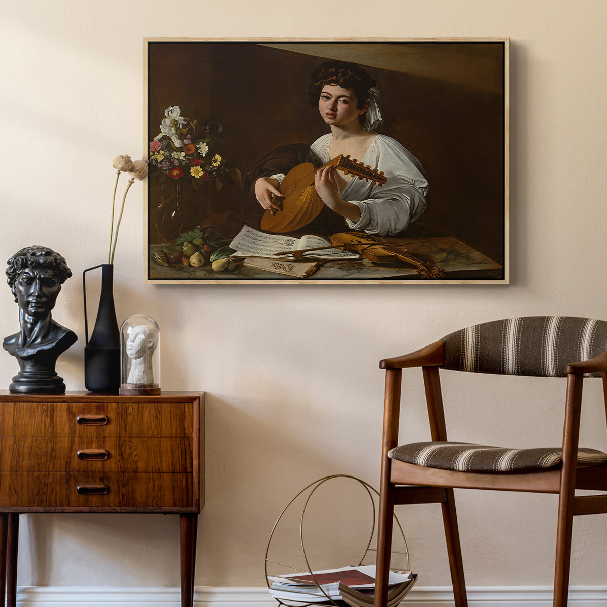 The Lute Player (Hermitage Version), c. 1596 by Caravaggio as a natural wood floater framed canvas featuring an intimate musical scene with instrument and decorative objects, styled above a mid-century console in a contemporary living area.