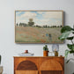 The Poppy Field near Argenteuil, 1873 by Claude Monet in a natural wood floater framed canvas featuring a field of red poppies with figures walking across rolling landscape, displayed above a wood console cabinet.
