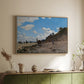 Natural wood floater framed canvas of The Beach at Honfleur, 1864 by Claude Monet, featuring an impressionist seaside with people and sailboats under bright sky above a sideboard in a softly lit hallway.