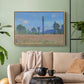 Natural wood floater framed canvas featuring a rural field filled with red blossoms beneath open sky, displayed above a sofa in a modern living room.