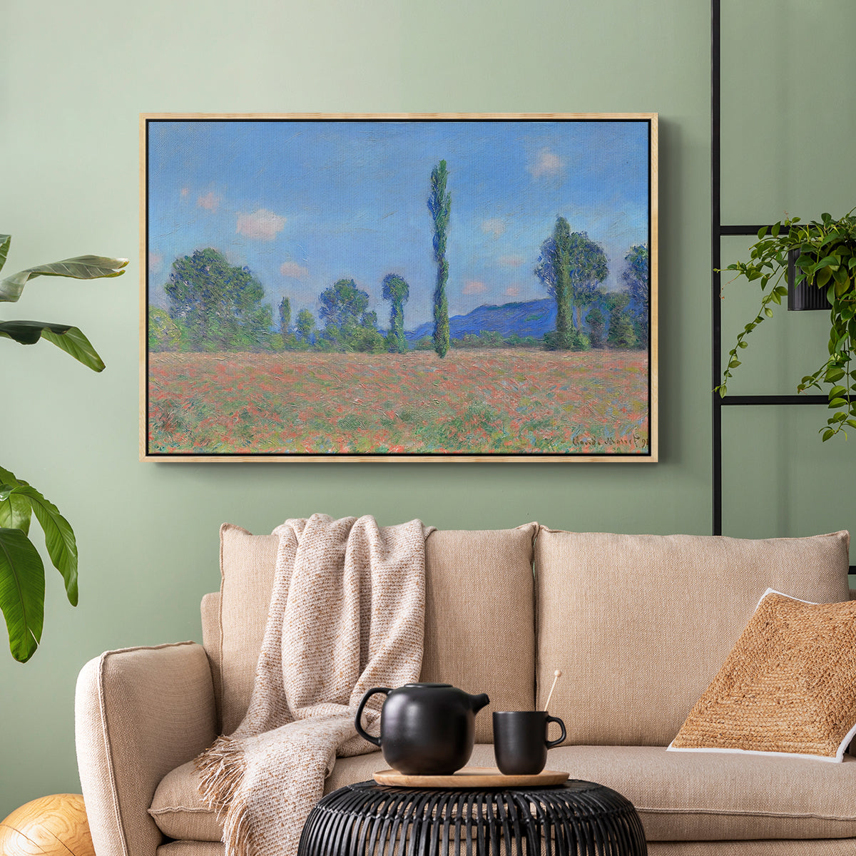 Natural wood floater framed canvas featuring a rural field filled with red blossoms beneath open sky, displayed above a sofa in a modern living room.