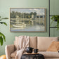 Natural wood floater framed canvas featuring a riverside view with architecture and nautical activity, displayed above a sofa in a modern living room.