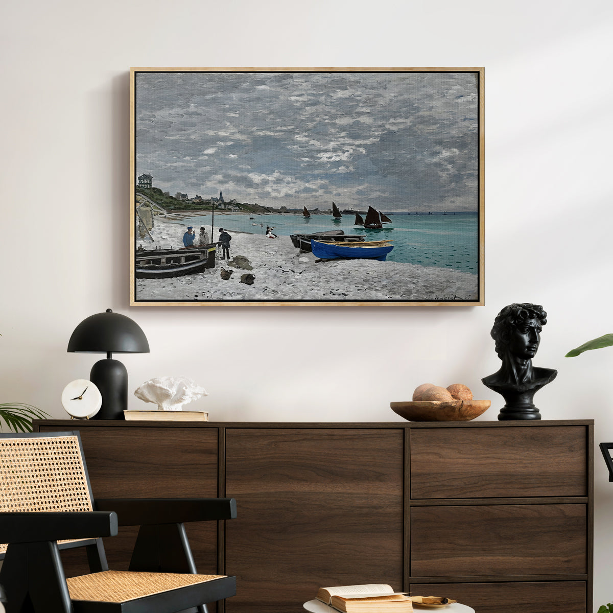 The Beach at Sainte-Adresse, 1867 by Claude Monet displayed in a natural wood floater framed canvas above a dark wood credenza in an entryway.