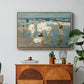 A Holiday, c. 1915 by Edward Henry Potthast in a natural wood floater framed canvas featuring people relaxing and wading in shallow ocean water along a sunny beach, displayed above a wood console cabinet.