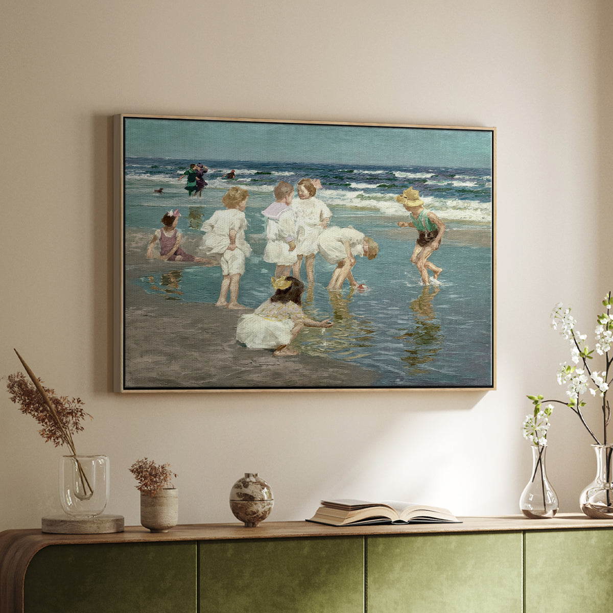Natural wood floater framed canvas of A Holiday, c. 1915 by Edward Henry Potthast, featuring a beach scene with figures bathing and standing in waves under bright sky above a sideboard in a softly lit hallway.