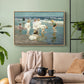 Natural wood floater framed canvas featuring a lively shoreline scene with people gathered in surf, displayed above a sofa in a modern living room.