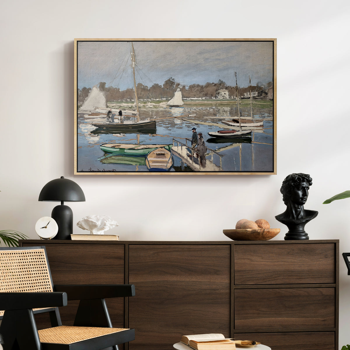 The Basin at Argenteuil, 1874 by Claude Monet displayed in a natural wood floater framed canvas above a dark wood credenza in an entryway.