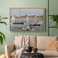 Natural wood floater framed canvas featuring a tranquil river setting with sailboats and shoreline, displayed above a sofa in a modern living room.