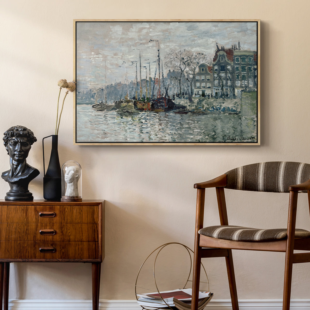 View of the Prins Hendrikkade and Kromme Waal in Amsterdam, 1874 by Claude Monet as a natural wood floater framed canvas featuring an urban waterway with docked boats and European buildings, styled above a mid-century console in a contemporary living area.