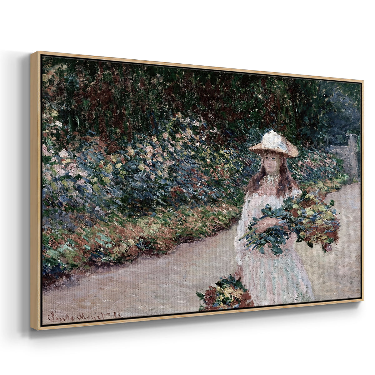 Angled view of Young Girl in the Garden at Giverny, 1888 by Claude Monet in a natural wood floater framed canvas.