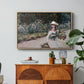 Young Girl in the Garden at Giverny, 1888 by Claude Monet in a natural wood floater framed canvas featuring a young girl seated in lush garden surrounded by blooming flowers, displayed above a wood console cabinet.