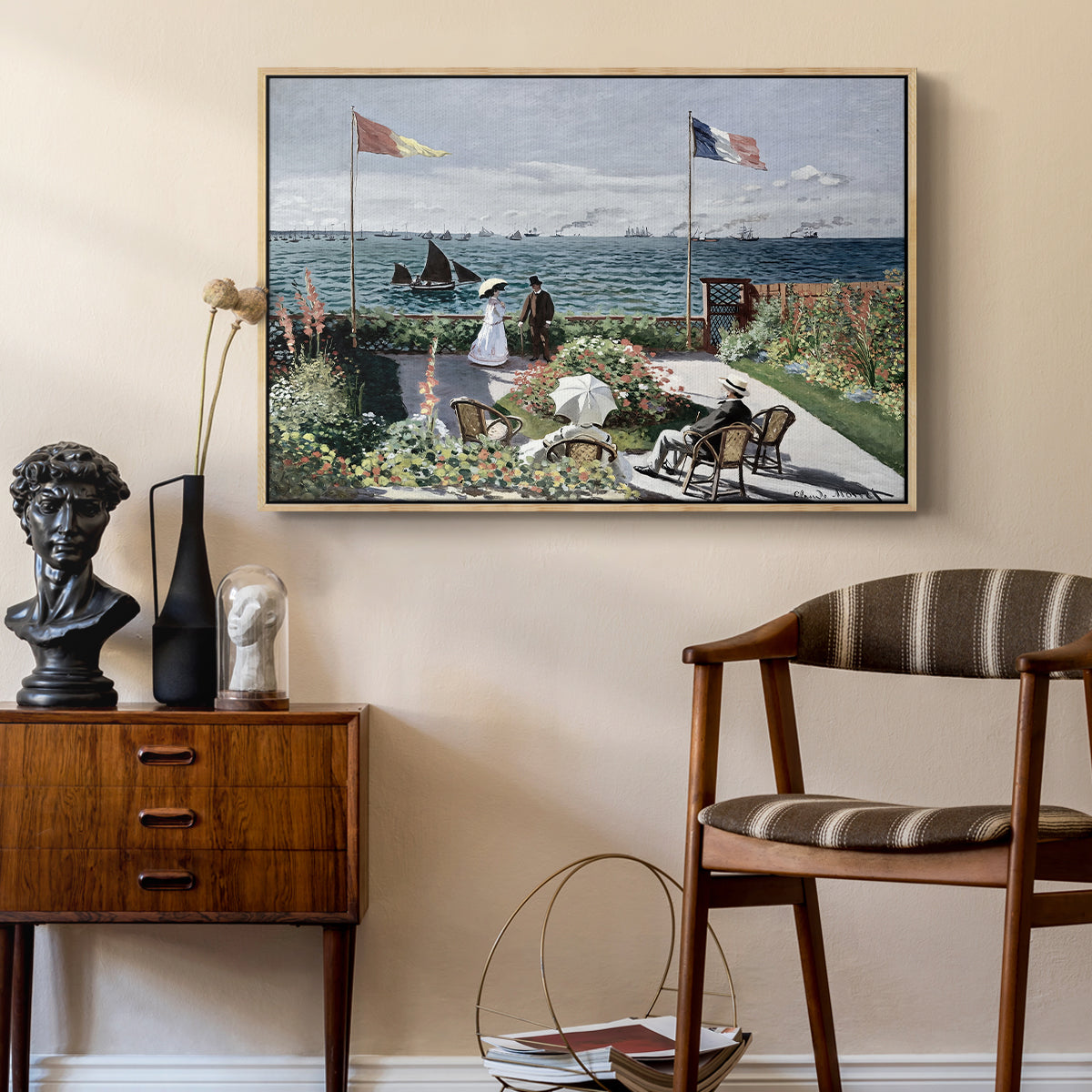 Garden at Sainte-Adresse, 1867 by Claude Monet as a natural wood floater framed canvas featuring a vibrant garden scene with colorful blooms and distant sea, styled above a mid-century console in a contemporary living area.