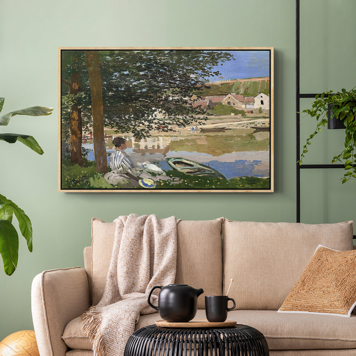 Natural wood floater framed canvas featuring a quiet outdoor setting with figures near river under foliage, displayed above a sofa in a modern living room.