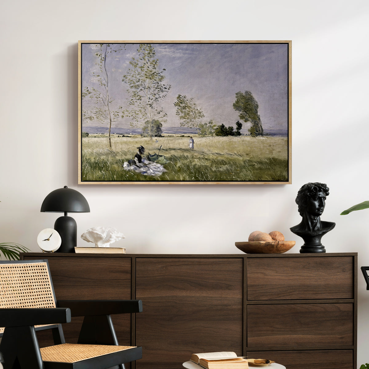 Summer (L'ete), 1874 by Claude Monet displayed in a natural wood floater framed canvas above a dark wood credenza in an entryway.
