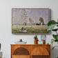 Summer (L'ete), 1874 by Claude Monet in a natural wood floater framed canvas featuring a woman seated in grassy field beneath tree in bright summer landscape, displayed above a wood console cabinet.