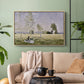 Natural wood floater framed canvas featuring a tranquil summer landscape with lone figure in nature, displayed above a sofa in a modern living room.