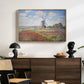 Tulip Fields with the Rijnsburg Windmill, 1886 by Claude Monet displayed in a natural wood floater framed canvas above a dark wood credenza in an entryway.