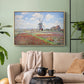 Natural wood floater framed canvas featuring a rural scene with patterned rows of flowers and windmill, displayed above a sofa in a modern living room.