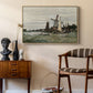 Windmill at Zaandam, 1871 by Claude Monet as a natural wood floater framed canvas featuring a rustic scene with windmill and reflections in water, styled above a mid-century console in a contemporary living area.