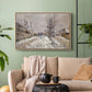 Natural wood floater framed canvas featuring an urban winter landscape with muted tones and soft light, displayed above a sofa in a modern living room.