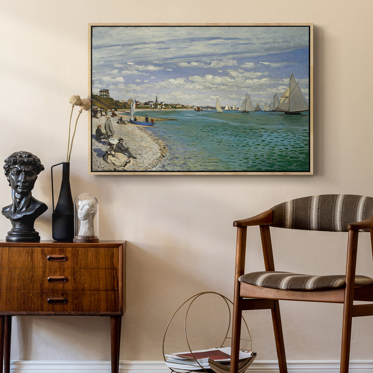 Regatta at Sainte-Adresse, 1867 by Claude Monet as a natural wood floater framed canvas featuring an impressionist coastal view with colorful sails and shoreline activity, styled above a mid-century console in a contemporary living area.