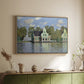 Natural wood floater framed canvas of Houses on the Zaan River at Zaandam, 1871 by Claude Monet, featuring an impressionist riverside village with colorful buildings above a sideboard in a softly lit hallway.