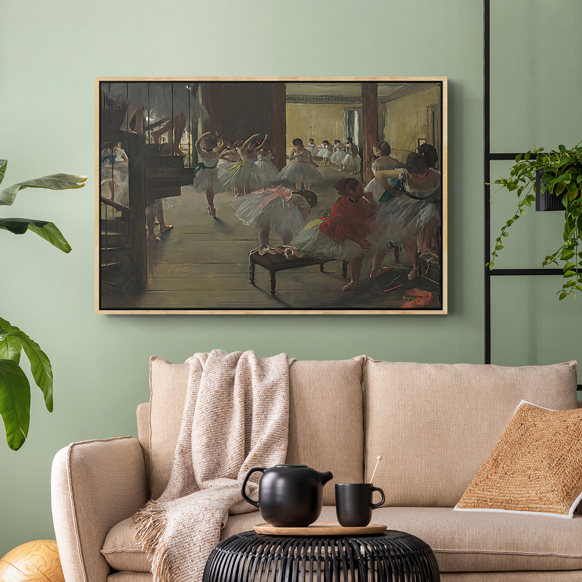Natural wood floater framed canvas featuring a group of dancers preparing during class with natural light, displayed above a sofa in a modern living room.