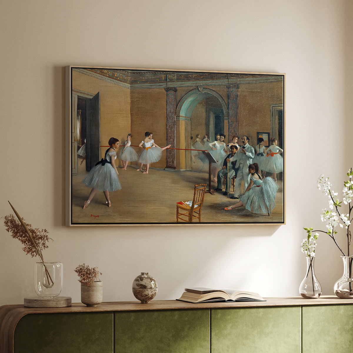 Natural wood floater framed canvas of The Dance Foyer at the Opera on the Rue Le Peletier, 1872 by Edgar Degas, featuring an interior scene of dancers waiting and stretching in large studio above a sideboard in a softly lit hallway.