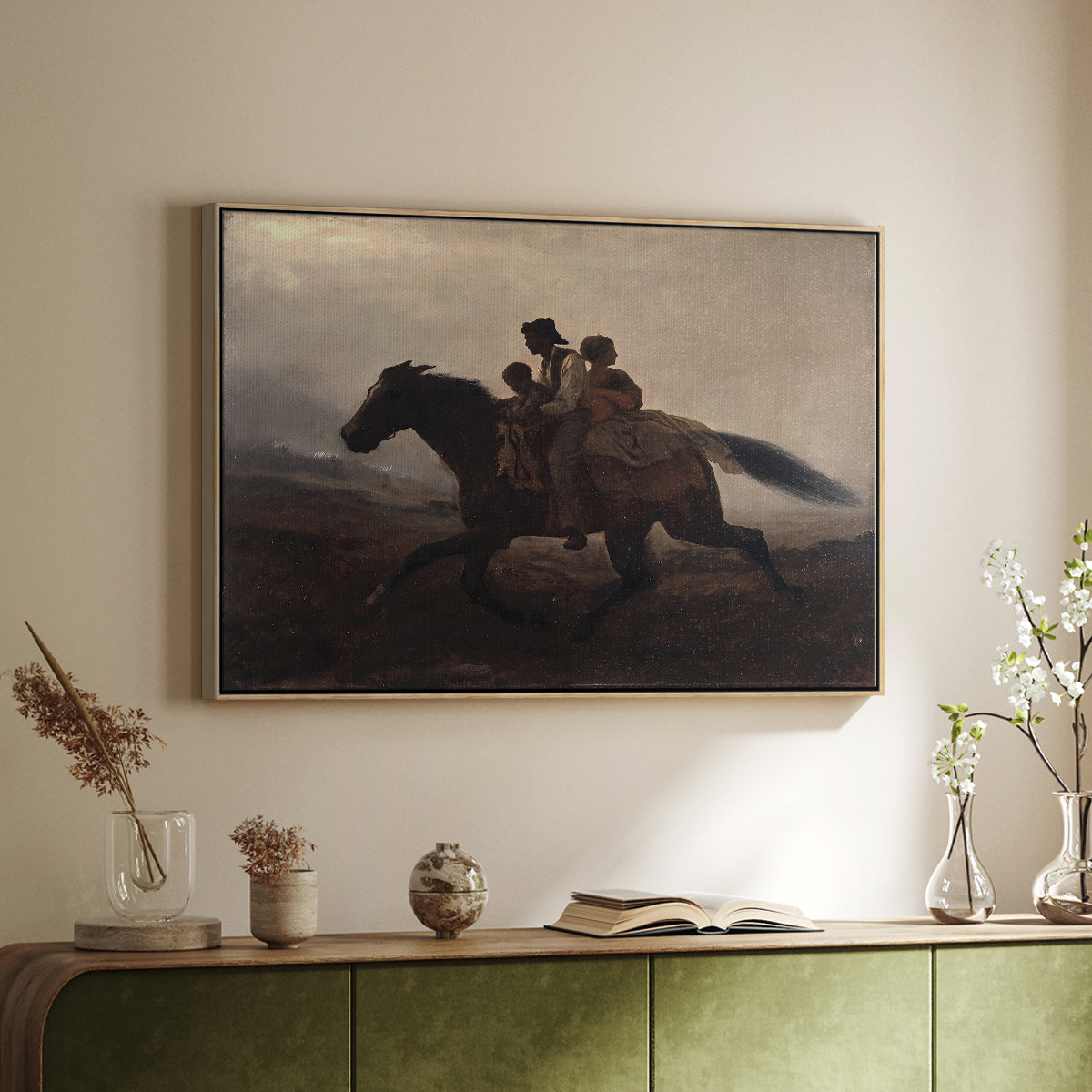 Natural wood floater framed canvas of A Ride for Liberty – The Fugitive Slaves, c. 1862 by Eastman Johnson, featuring a dramatic scene of enslaved people fleeing on horseback in darkness above a sideboard in a softly lit hallway.
