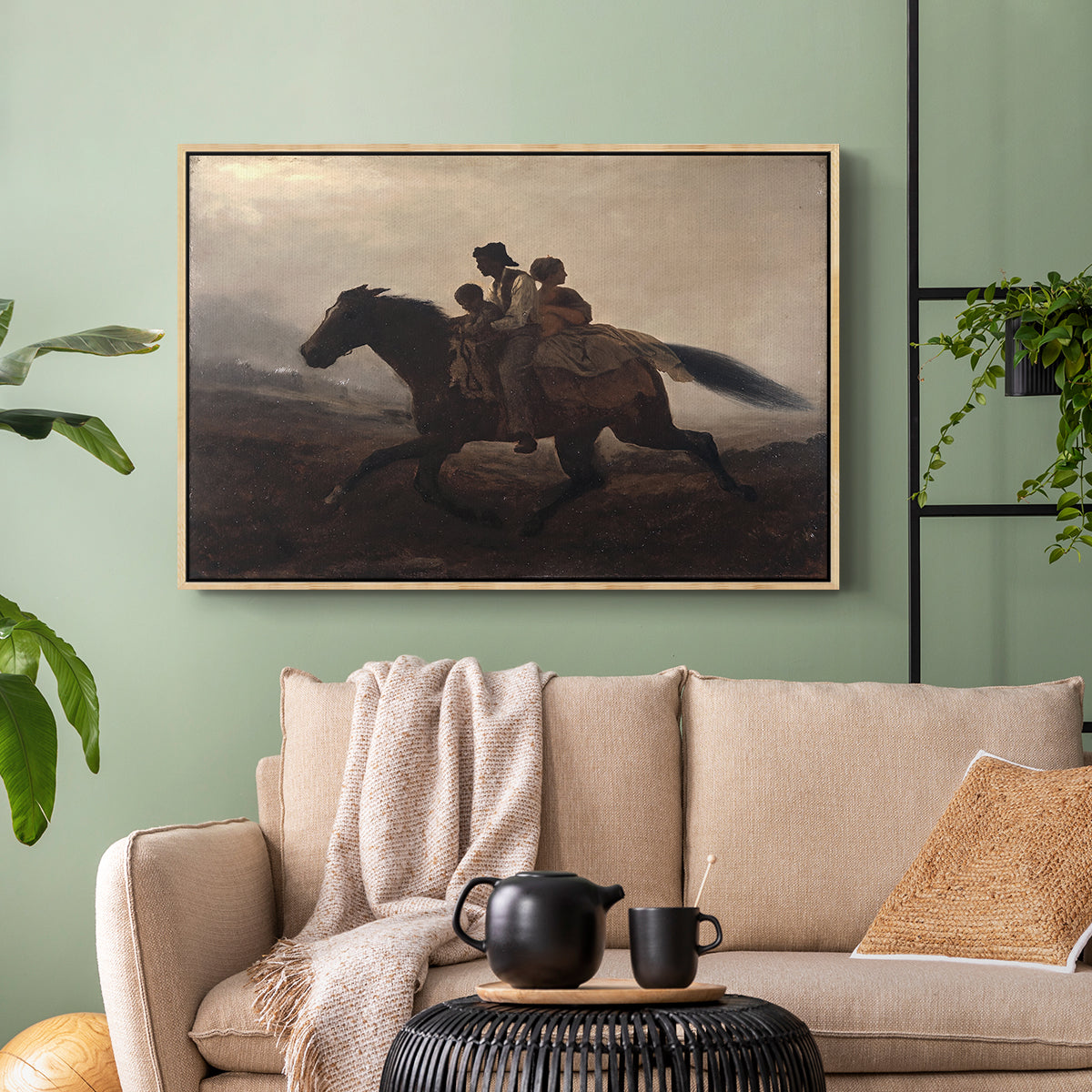 Natural wood floater framed canvas featuring figures on horse moving swiftly through shadowy landscape, displayed above a sofa in a modern living room.