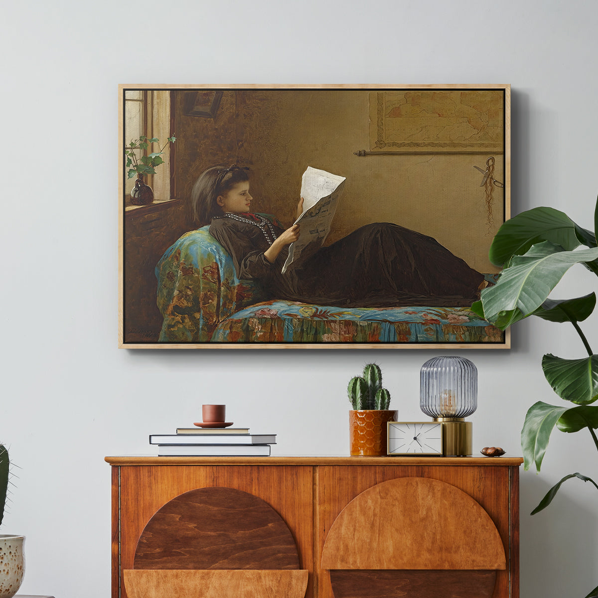 Interesting News, 1872 by Eastman Johnson in a natural wood floater framed canvas featuring a group of people gathered indoors reading newspaper together, displayed above a wood console cabinet.