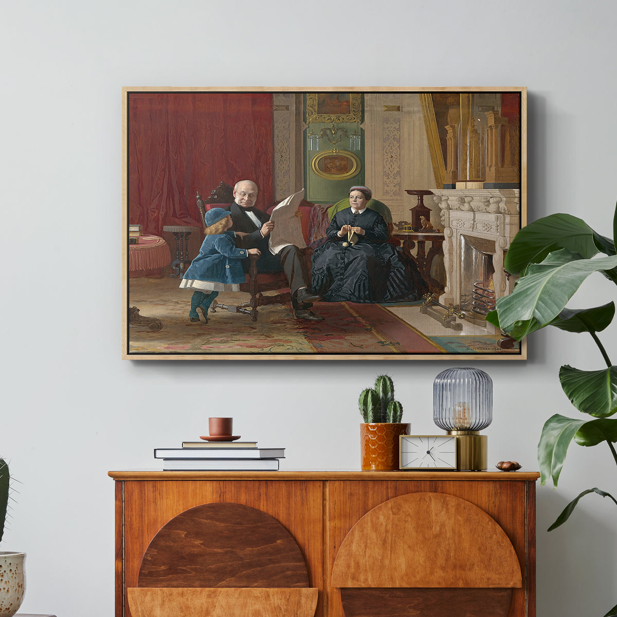The Brown Family, 1869 by Eastman Johnson in a natural wood floater framed canvas featuring a family seated together in interior room engaged in quiet activity, displayed above a wood console cabinet.
