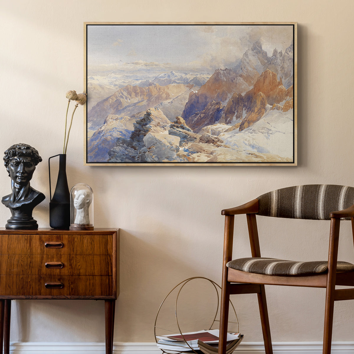 Col du Géant, 1903 by Edward Theodore Compton as a natural wood floater framed canvas featuring a panoramic alpine view with snow and rocky cliffs, styled above a mid-century console in a contemporary living area.