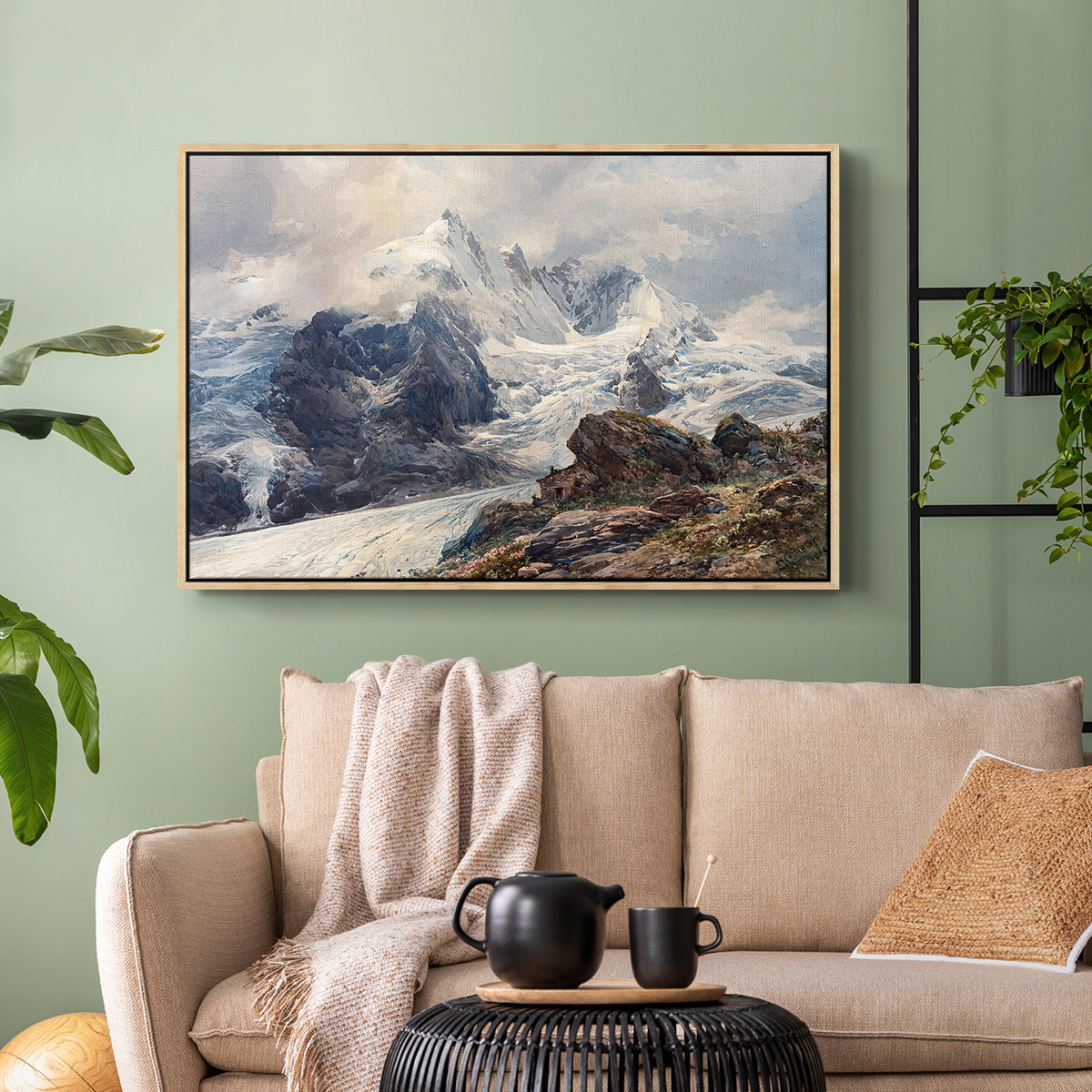 Natural wood floater framed canvas featuring an alpine peak dominating surrounding terrain, displayed above a sofa in a modern living room.