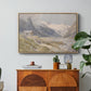 Shepherds (Pasterze), c. 1921 by Edward Theodore Compton in a natural wood floater framed canvas featuring a small group of shepherds in alpine landscape with grazing animals, displayed above a wood console cabinet.