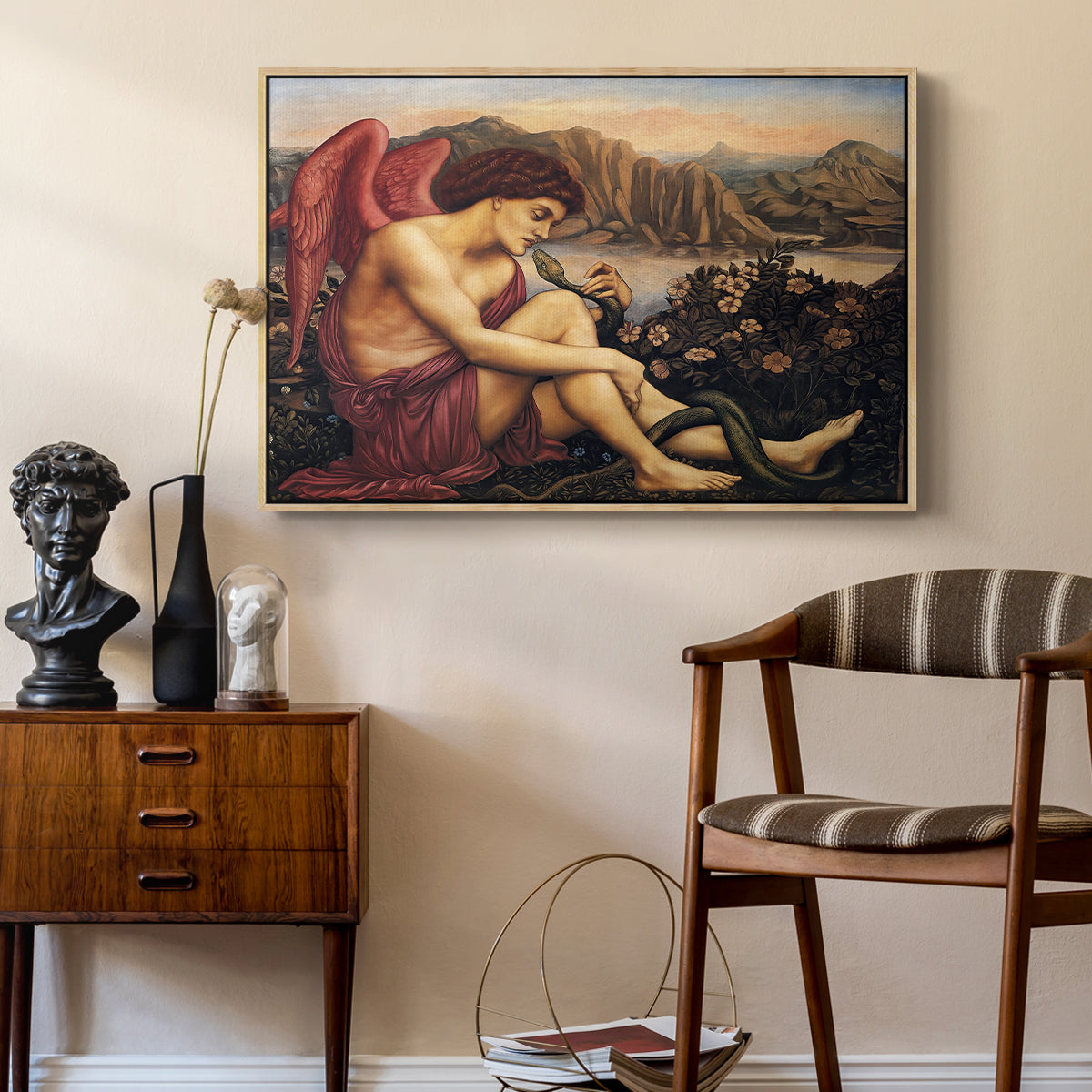 The Angel with the Serpent, c. 1870-1875 by Evelyn De Morgan as a natural wood floater framed canvas featuring a religious scene with angel defeating snake in dramatic pose, styled above a mid-century console in a contemporary living area.