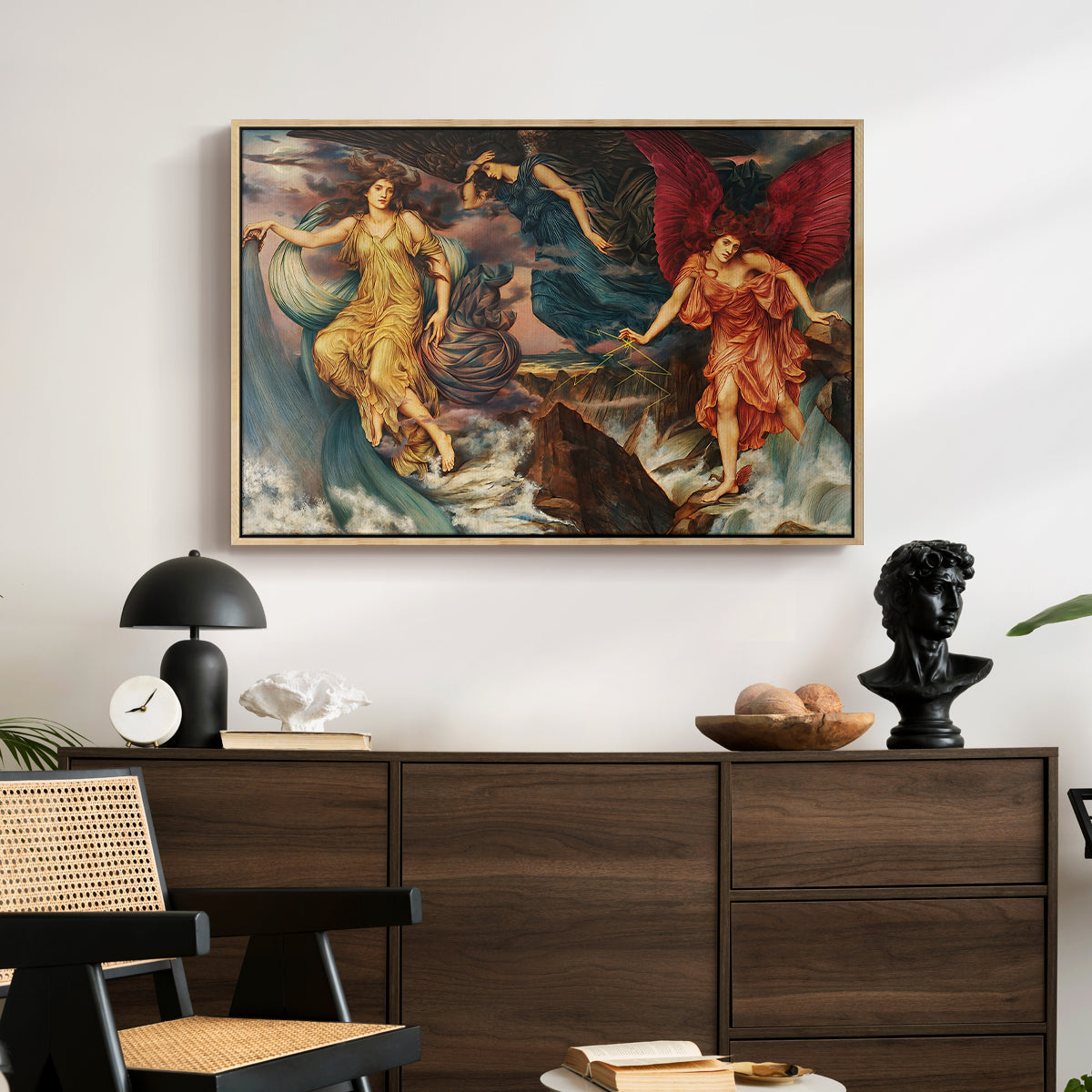 The Storm Spirits, 1900 by Evelyn De Morgan displayed in a natural wood floater framed canvas above a dark wood credenza in an entryway.