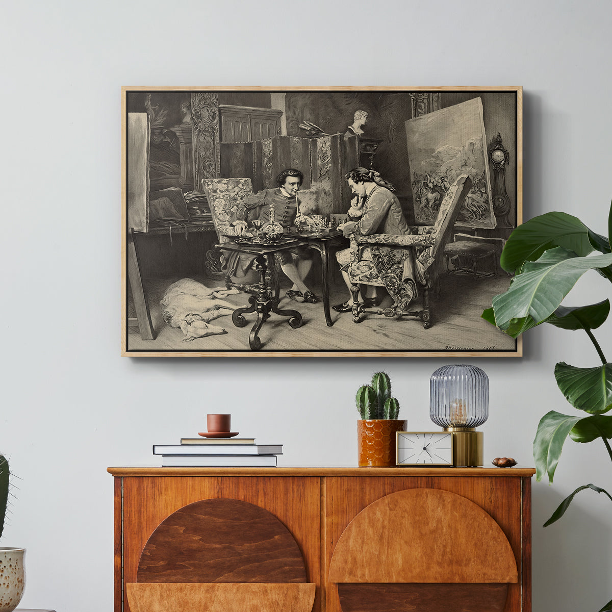 The Chess Players, 1858 by Ernest Meissonier in a natural wood floater framed canvas featuring two men seated at table playing chess in detailed interior setting, displayed above a wood console cabinet.