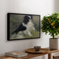 Tama, the Japanese Dog, c. 1876 by Pierre-Auguste Renoir, presented in a black floater framed canvas featuring a small black and white dog standing in shallow water with soft brushstrokes, displayed above a hallway console table.