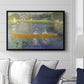 The Skiff (La Yole), 1875 by Pierre-Auguste Renoir displayed above a sofa in a living room in a black floater frame, featuring an impressionist boating scene with people relaxing in a narrow skiff.