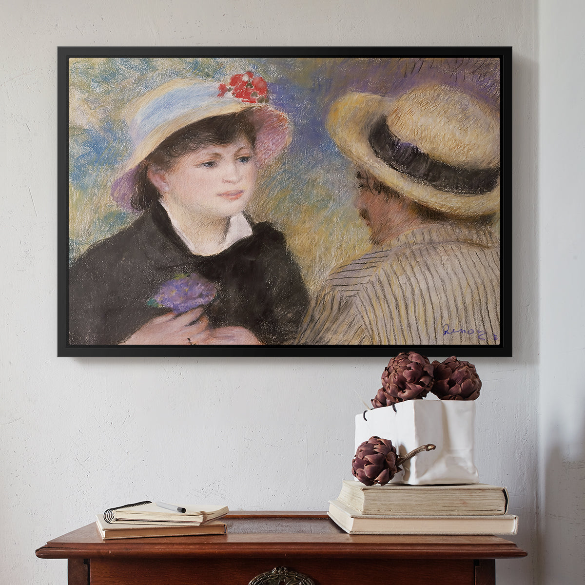 Black floater framed canvas featuring Boating Couple (Aline Charigot and Renoir), c. 1881 by Pierre-Auguste Renoir above an entryway table in a minimalist foyer.