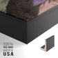Close-up of the black floater frame corner and gallery wrapped canvas construction.