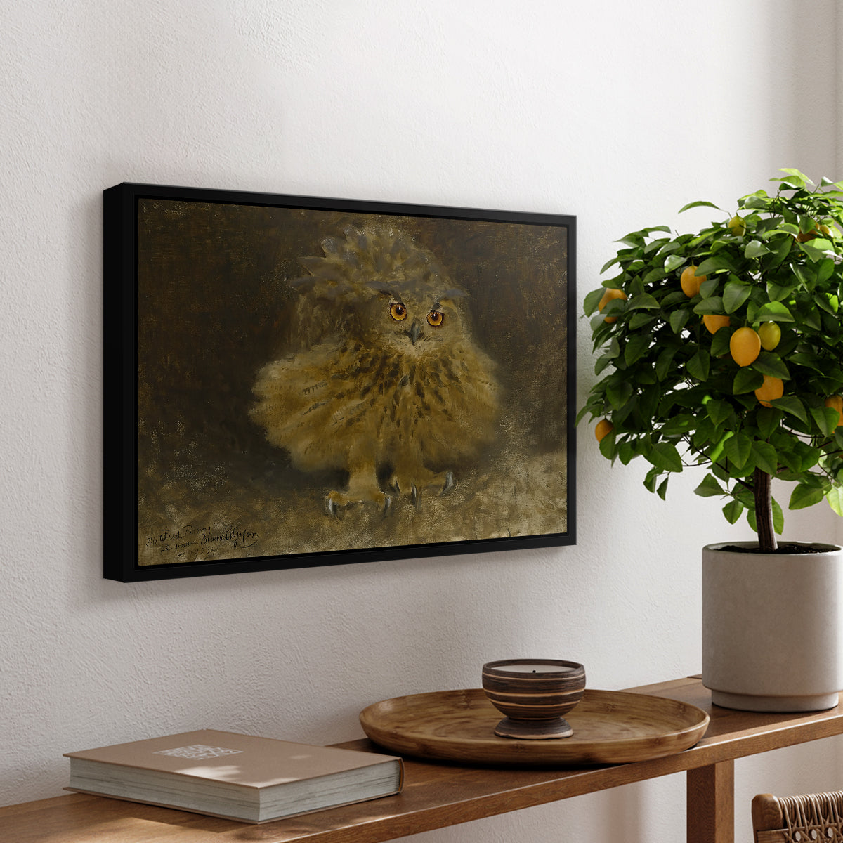 An Eagle Owl (Berguv), 1905 by Bruno Liljefors, presented in a black floater framed canvas featuring a large owl perched on branch in shadowy natural forest setting, displayed above a hallway console table.