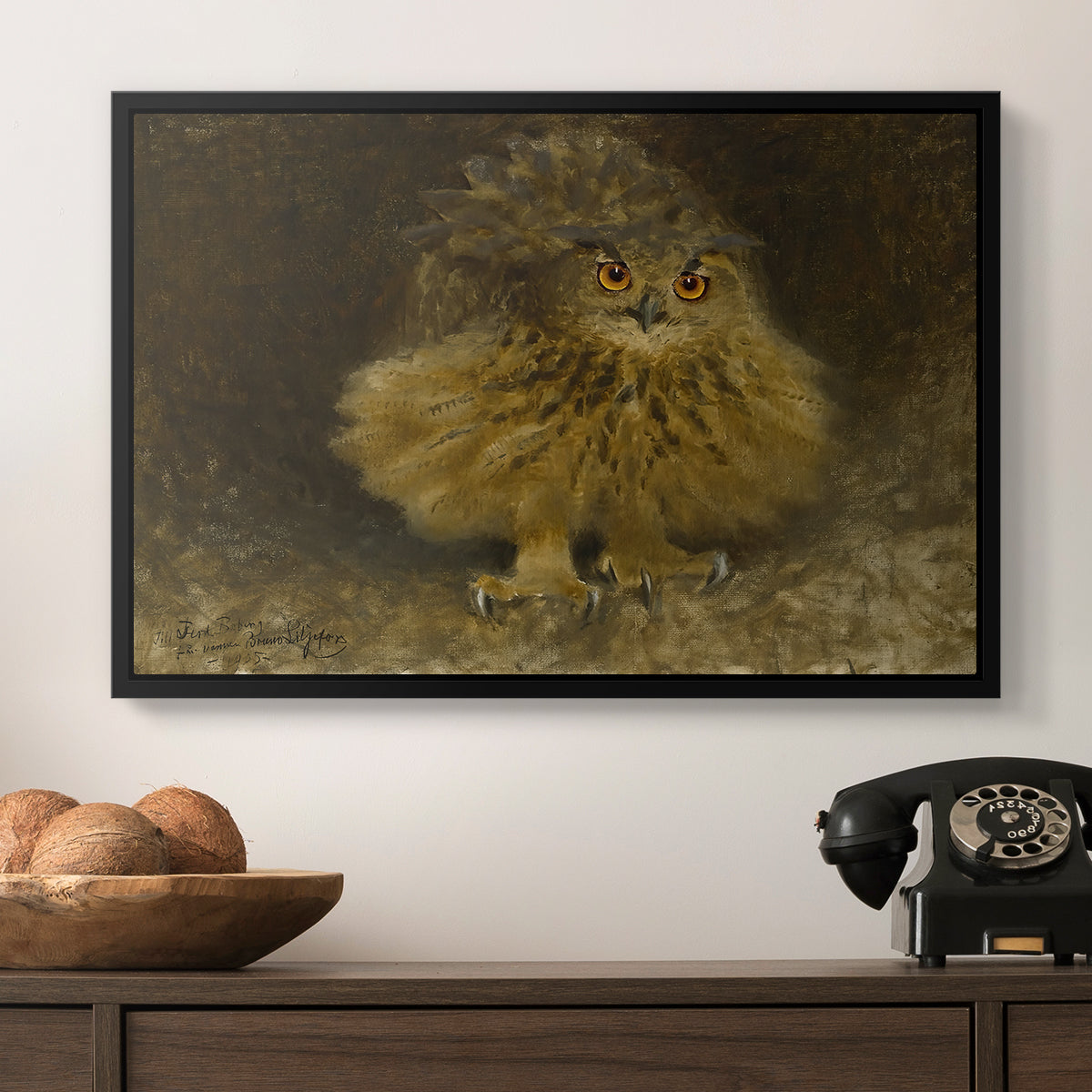 An Eagle Owl (Berguv), 1905 by Bruno Liljefors in a black floater framed canvas displayed above a console table in a hallway, featuring a realistic depiction of owl camouflaged within woodland environment.