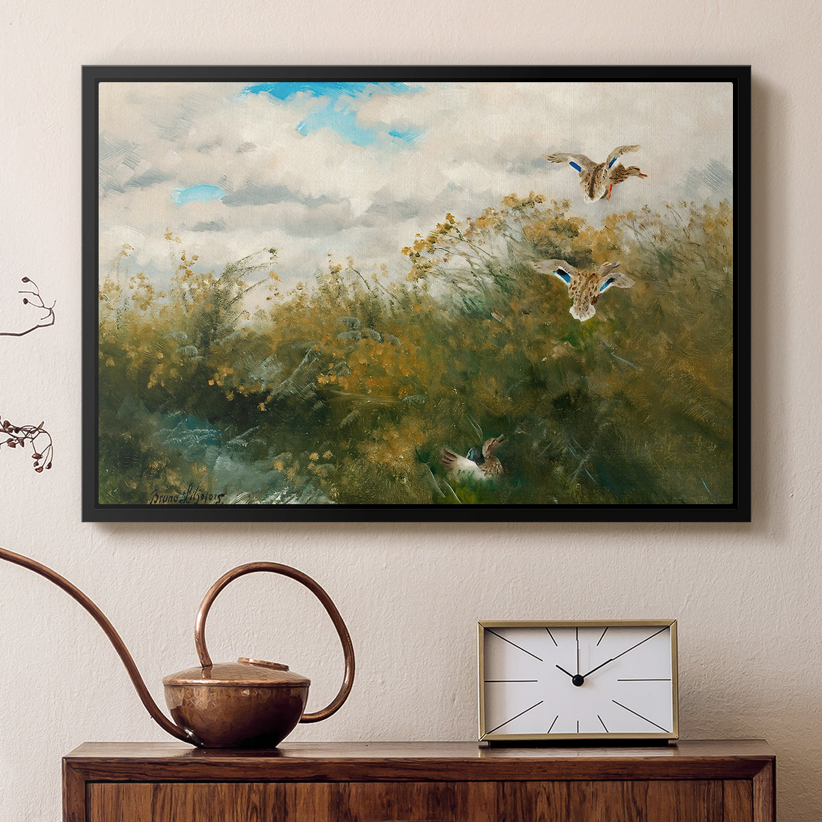 Black floater framed canvas featuring a group of ducks foraging in natural marsh setting, displayed above a cabinet in a soft-toned living room.