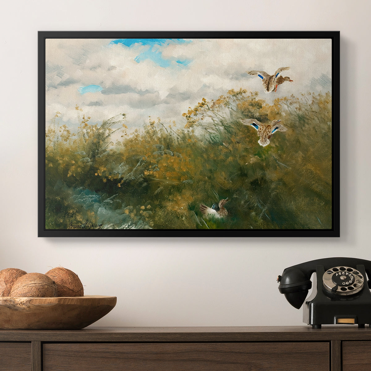 Wild Ducks (Grasänder), 1890 by Bruno Liljefors in a black floater framed canvas displayed above a console table in a hallway, featuring a realistic depiction of ducks in countryside landscape.