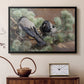 Black floater framed canvas featuring a realistic scene of crows interacting on grassy terrain, displayed above a cabinet in a soft-toned living room.